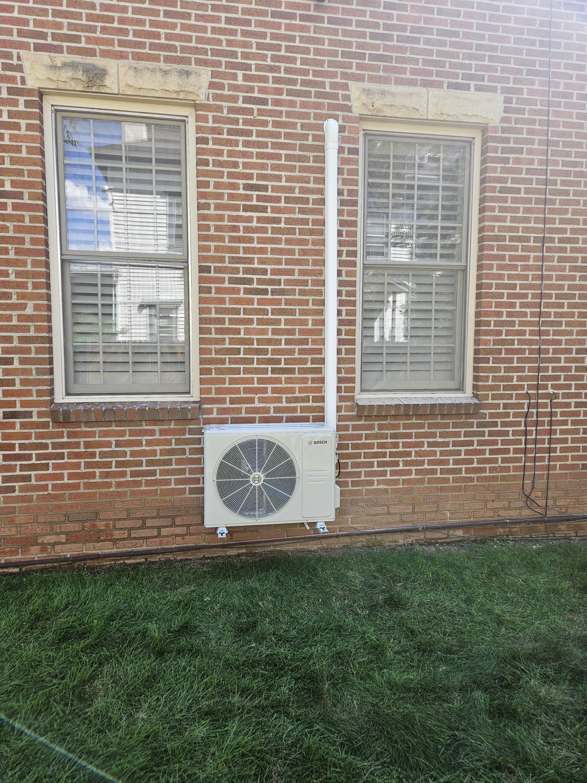 A picture of a mini split air conditioning unit outside of a home.