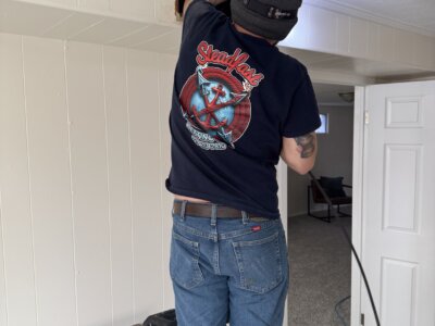 A picture of a guy working on a ceiling vent.